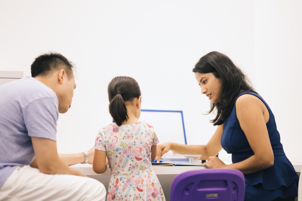 Anushki interacting with a young client with her dad present.