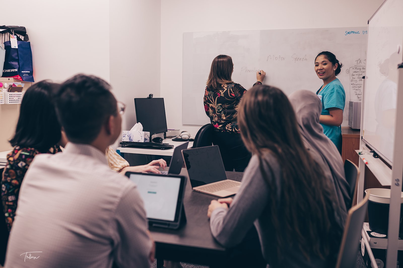 A group of Speech Pathologists learning from their team directors.